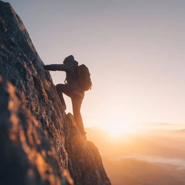 life coaching in a group online man climbing mountain after coaching