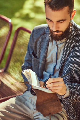 Portrait,Of,A,Bearded,Male,In,Casual,Clothes,,Writes,Something