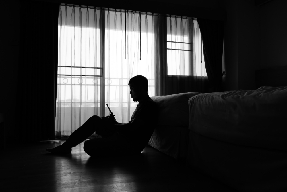 Silhouette,Of,Man,With,Smartphone,Over,Private,Room,Window,Background